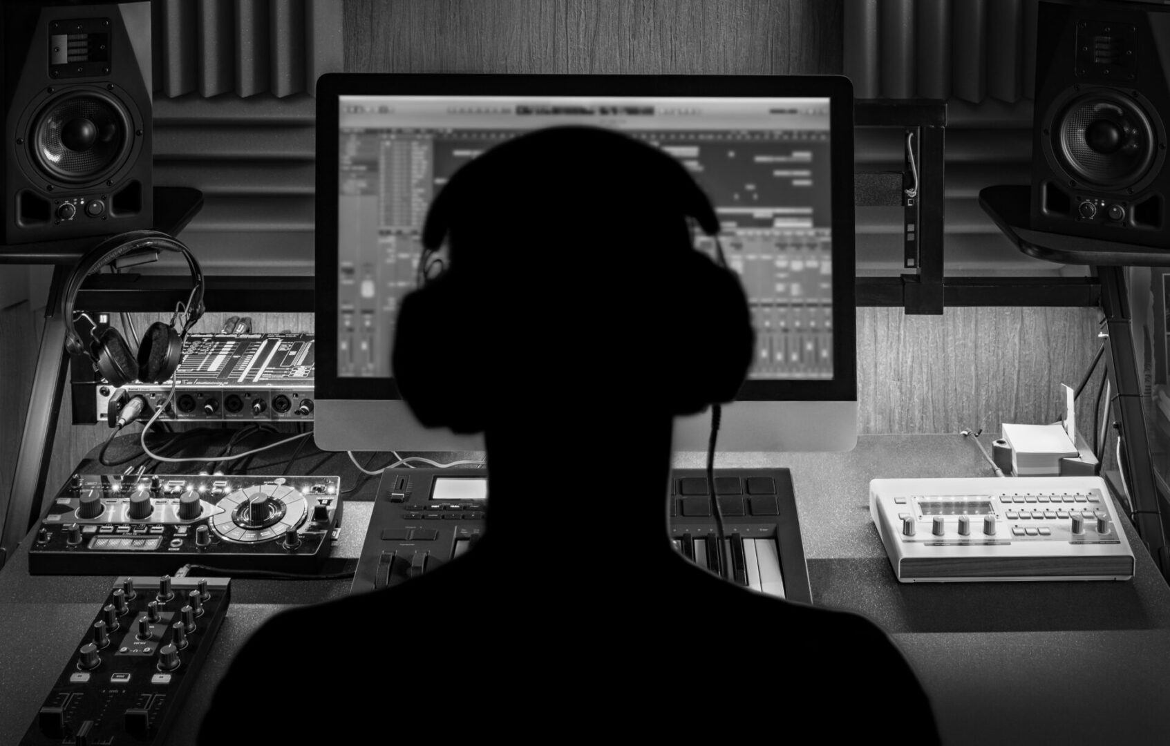 Man produce electronic music in project home studio.